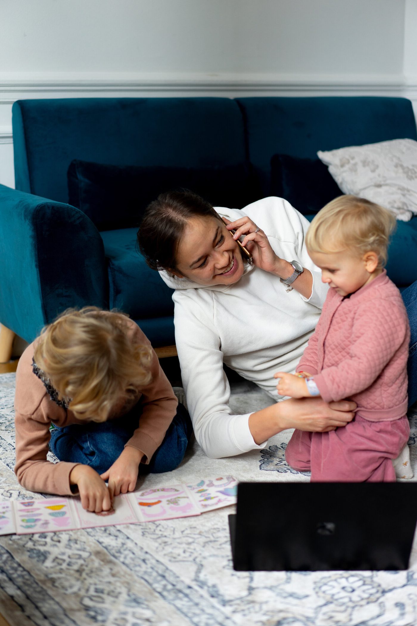 Aliya playing with her kids on the floor